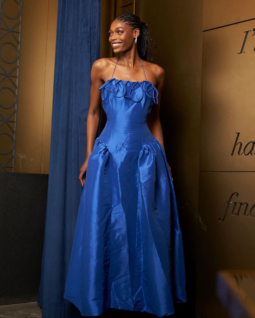 BLACK WOMAN IN A NAVY-BLUE EVENING DRESS IN COLOR